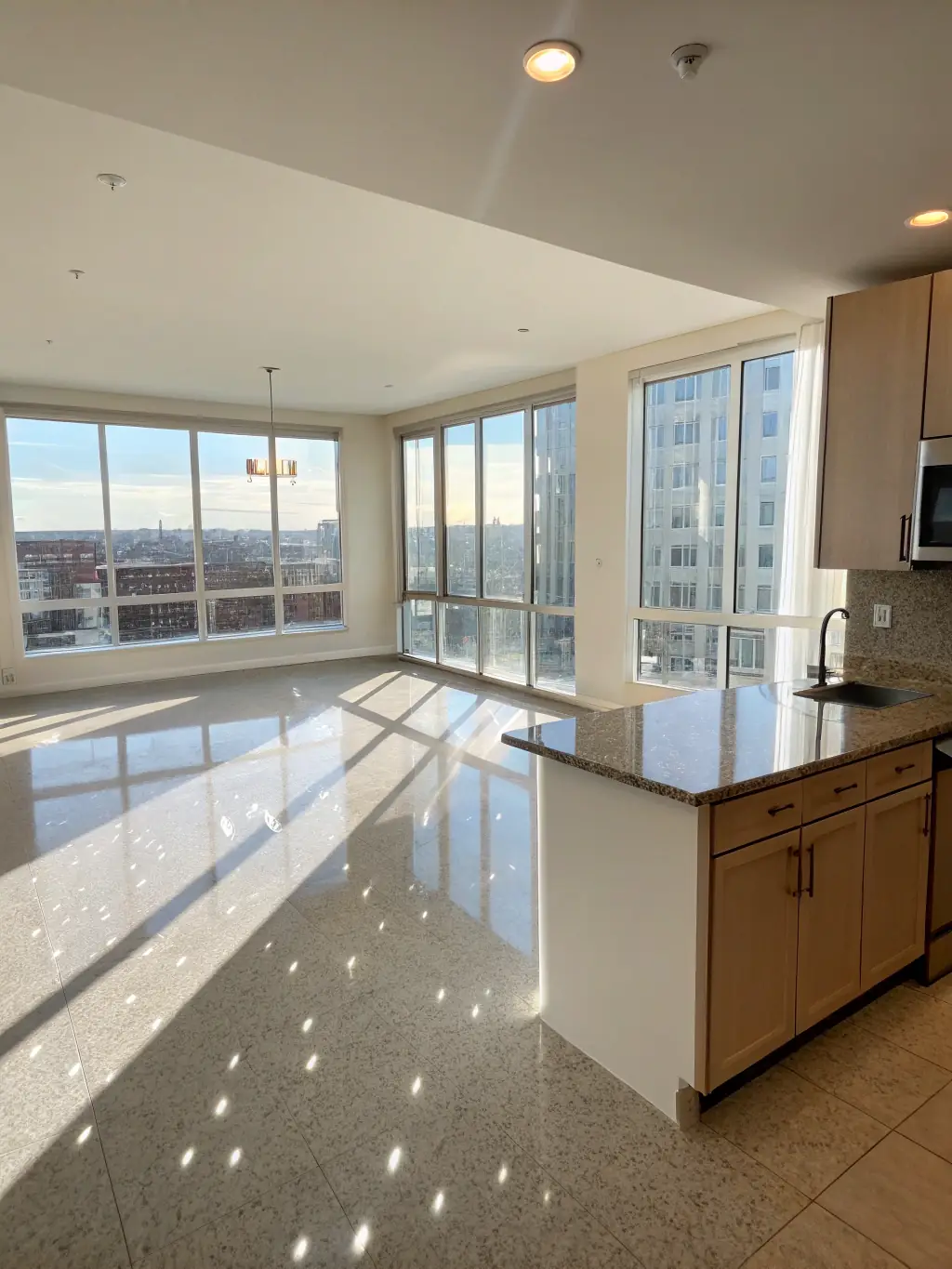 An empty, spotless apartment after NeatZest Cleaning's end-of-tenancy cleaning, emphasizing the cleanliness of the floors and windows.